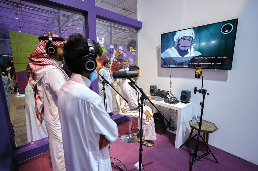 Saudi Anime Expo attendees enjoy playing with dubbing The Journey at Manga Productions’ booth. The experience demonstrates the popularity in the country of both the film’s origin story and anime.