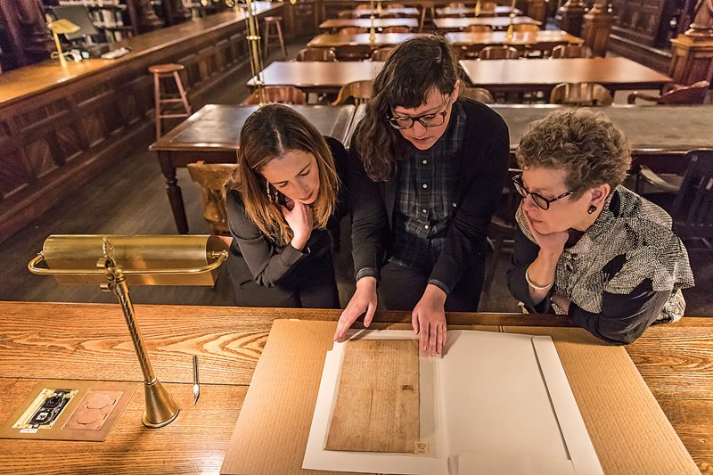 “Anthony van Salee’s land deed is an entry point into essential themes—race, religion, gender and law—that mark Brooklyn’s history across centuries,” says Julie Golia, left, curator for history, social sciences and government at the New York Public Library. This document, signed in 1643 by New Netherland Director General Willem Kieft, affirmed van Salee’s rights to 100 morgens—about 80 hectares—as well as other properties along the south shore of what was then called Breukelen. Under its terms, he paid a portion of his earnings to the Dutch West India Company. Examining the document with Golia are, at center, former Brooklyn Historical Society President Deborah Schwartz and, right, archivist and public historian Maggie Schreiner.