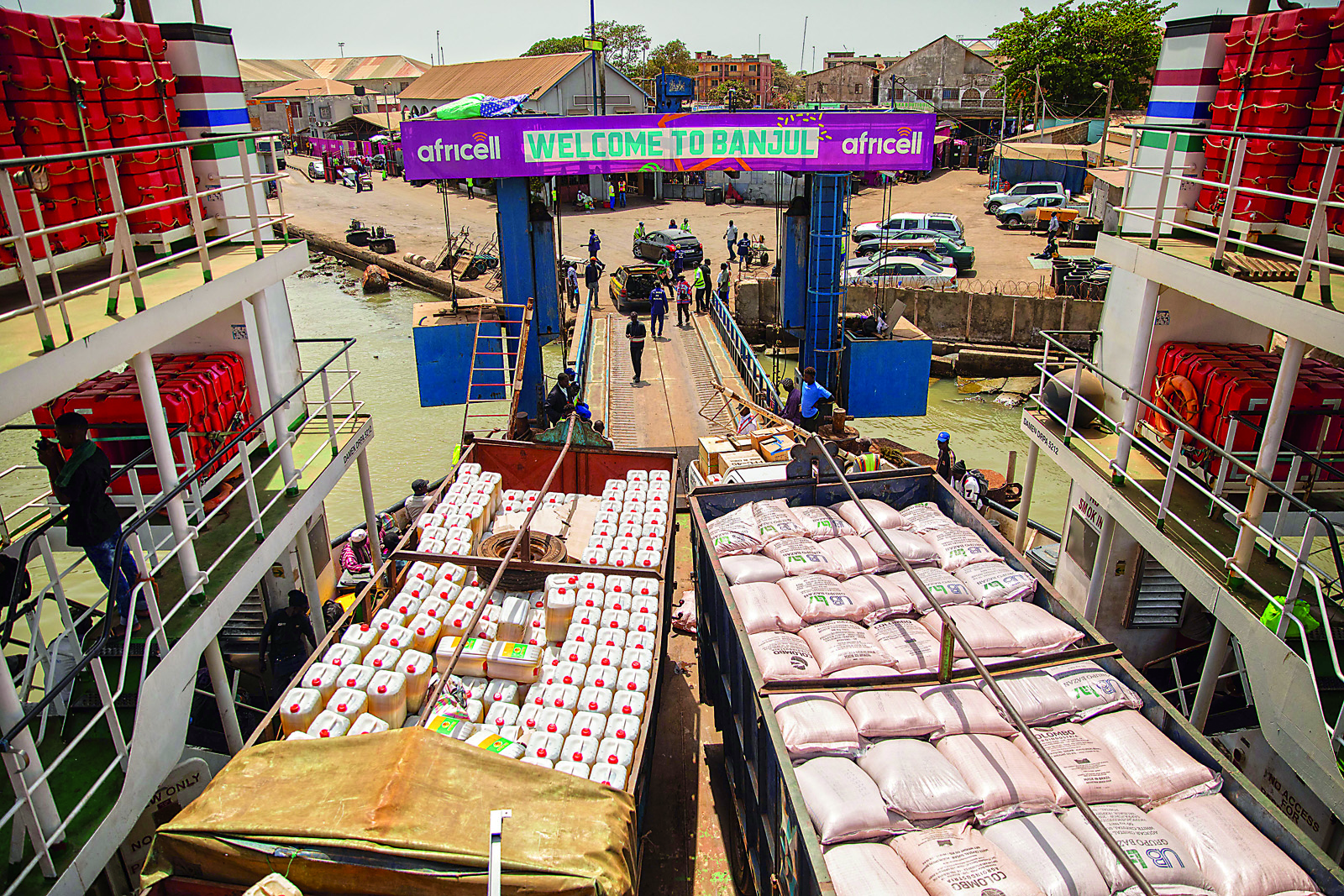 Trucks loaded with agricultural products fill the deck of the ferry that connects Banjul with Barra across the River Gambia. The river runs the length of Gambia and roughly divides it. 