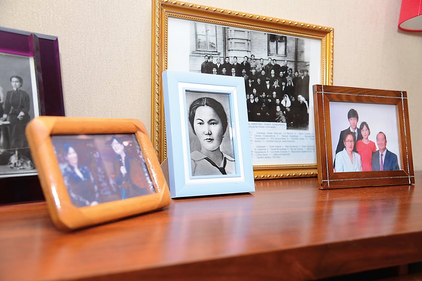 In her home in Almaty, Kazakhstan, Doszhanova’s granddaughter Aizhan Yershina proudly maintains a shelf of family photos that includes a portrait of her grandmother as a young woman taken from a 1913 photo, lower, that shows Doszhanova flanked by classmates at the time of her graduation from secondary school at the Women’s Gymnasium of Orenburg.